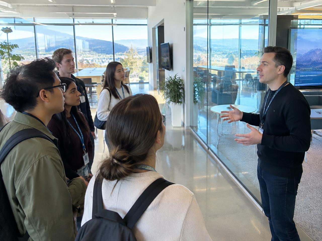 Participants listening to a host during a tech company visit