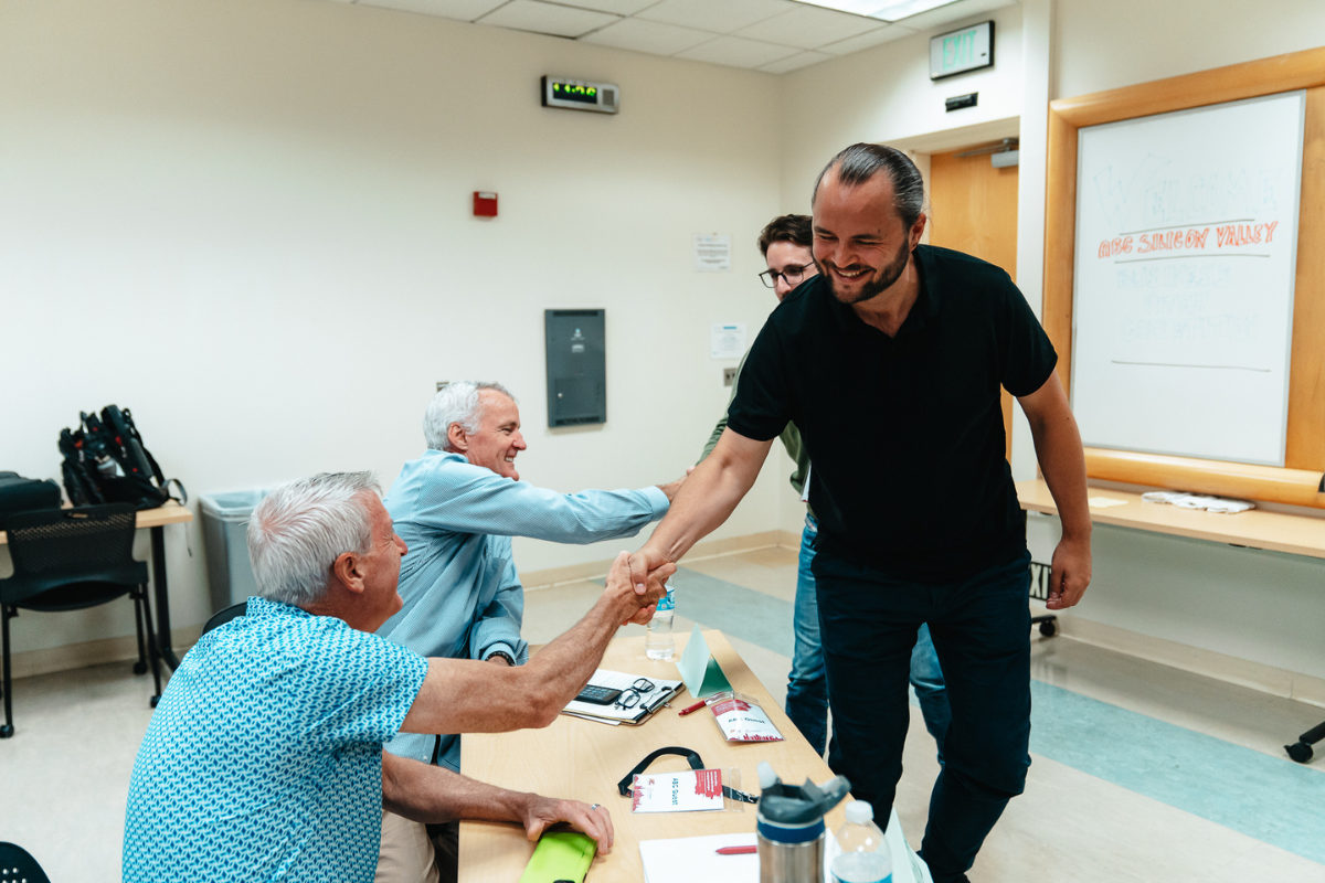 The picture shows the end of the pitching competition at ABC Silicon Valley 2024 where the participants shake hands with the judges.