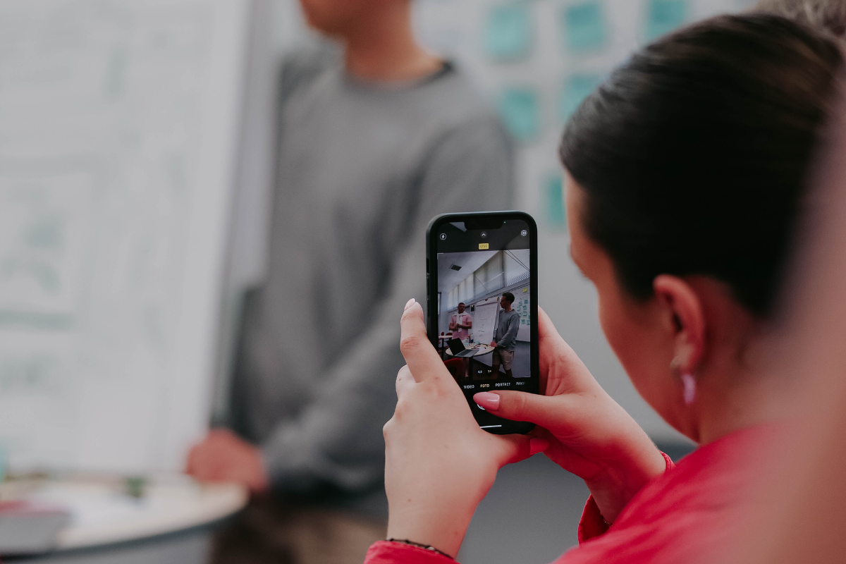 Pictured is an ABC Silicon Valley attendee photographing other attendees presenting.