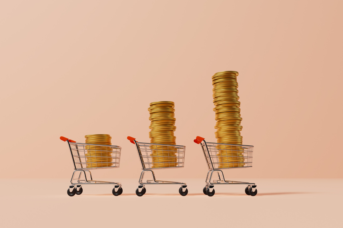 Shopping trolly with a stack of gold coins, suggests the inflation concept.