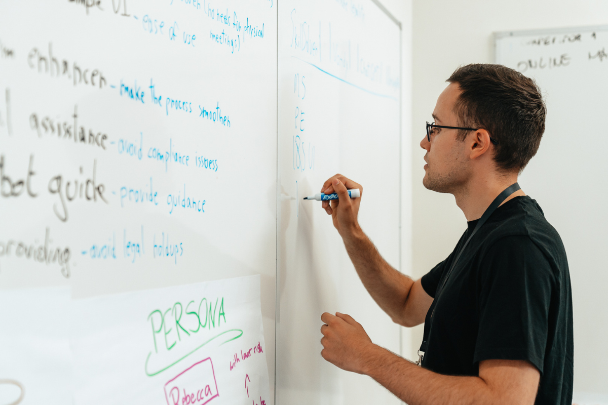 The picture shows an ABC Silicon Valley attendee writing on the board.