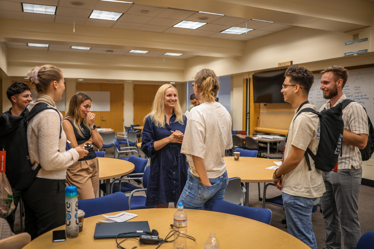 The picture shows Ana Lukner, one of the guest speakers, talking to participants after her lecture.