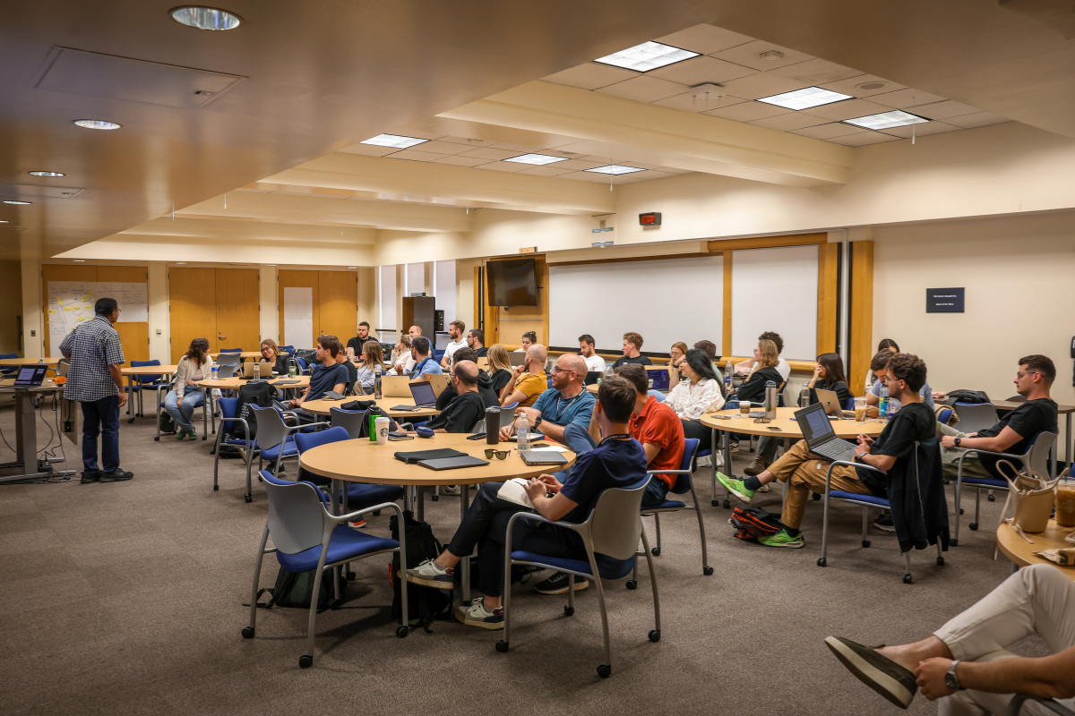 The picture shows participants in the classroom listening to a guest lecture by Sri Peruvemba.