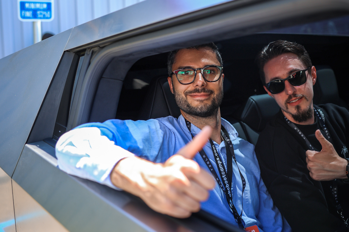 The picture shows two participants in a Cybertruck at the Tesla Fremont Factory.