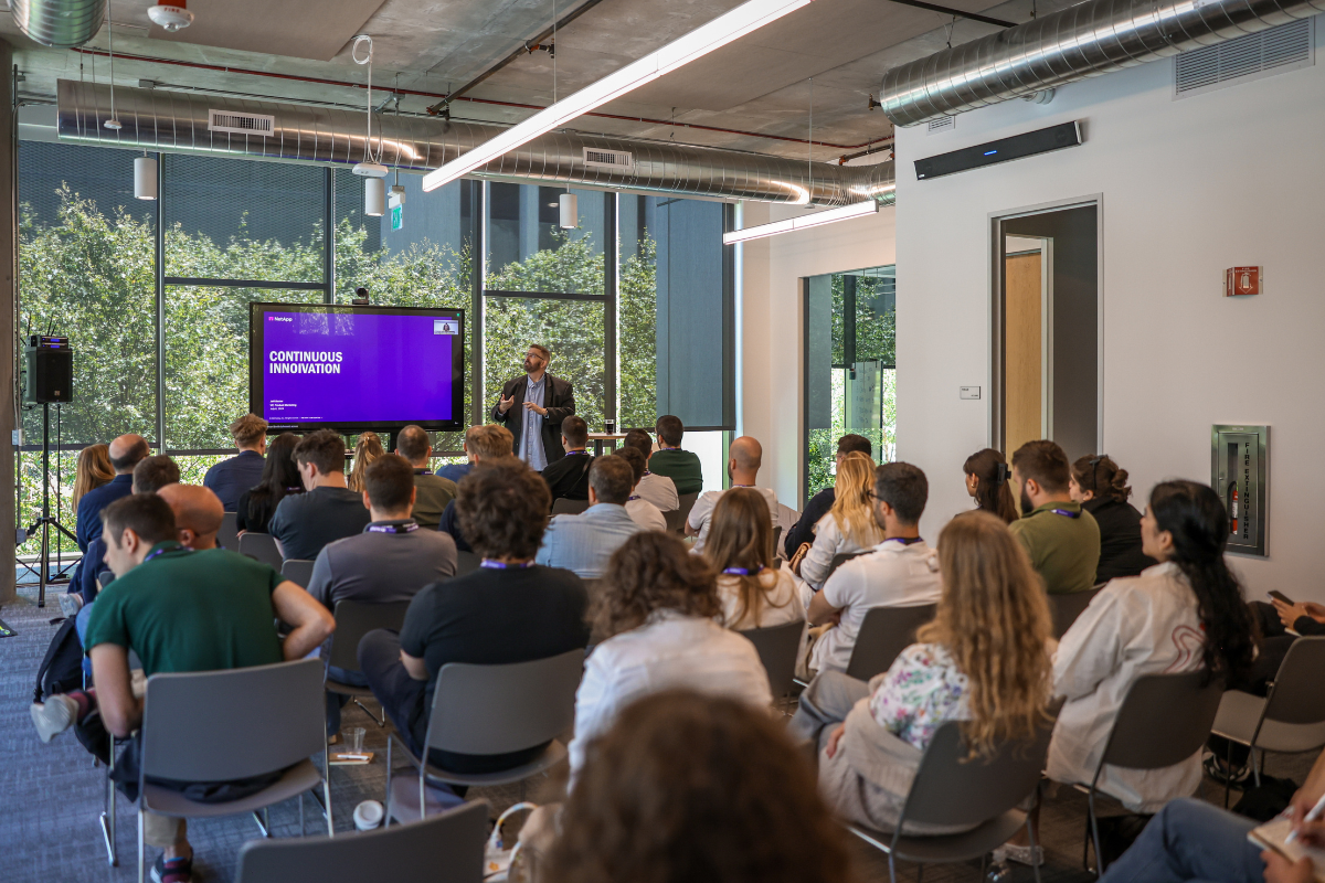 Pictured are ABC Silicon Valley 2025 attendees listening to Jeff Baxter's lecture during a visit to NetApp.
