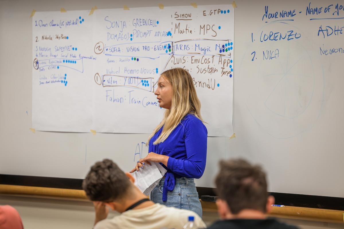 A woman in a blue shirt named Nika, one of the ABC Silicon Valley participants, is presenting.